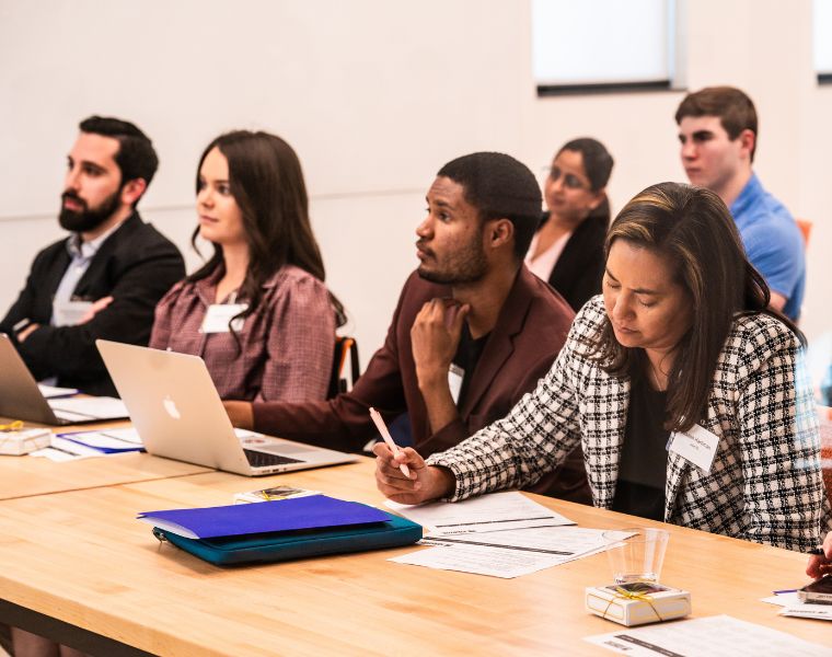 A group of participants listen and take notes at 2023 Morgenthaler-Pavey Startup Competition, captured by Character Studies Photography.