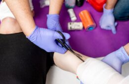 Showing how to apply a bandage on injured person, close-up view from above