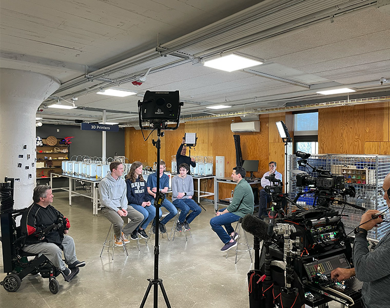 Photo of students being interviewed by NBC News in Sears thinkbox