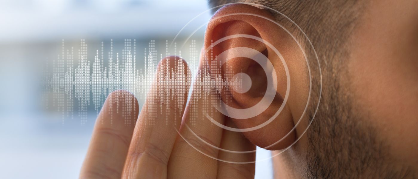 Young man with hearing problems or hearing loss. Hearing test concept
