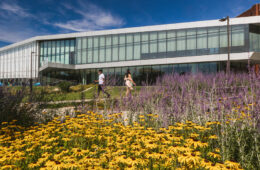 Photo of Tinkham Veale University Center with flowers in the foreground