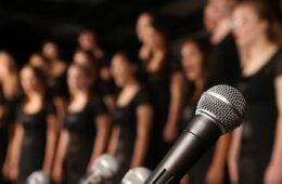 Shot of microphones with choir in the background