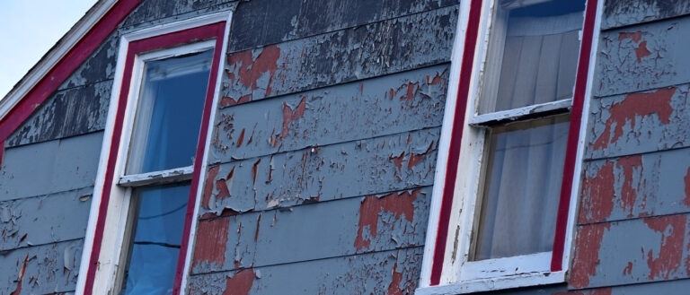 peeling paint on an abandoned house