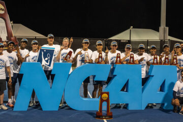 The CWRU men's tennis team poses by a large NCAA sign after winning their first national championship