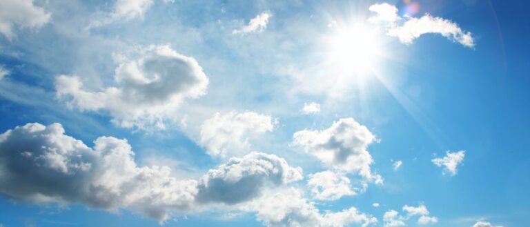White clouds and sun in blue sky