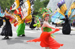 Photo of people dancing as butterflies during a Parade the Circle event