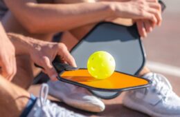 Close up of pickleball racket and ball