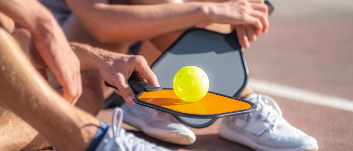 Close up of pickleball racket and ball