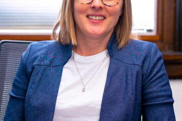 Photograph of Lydia Kisley seated at a desk