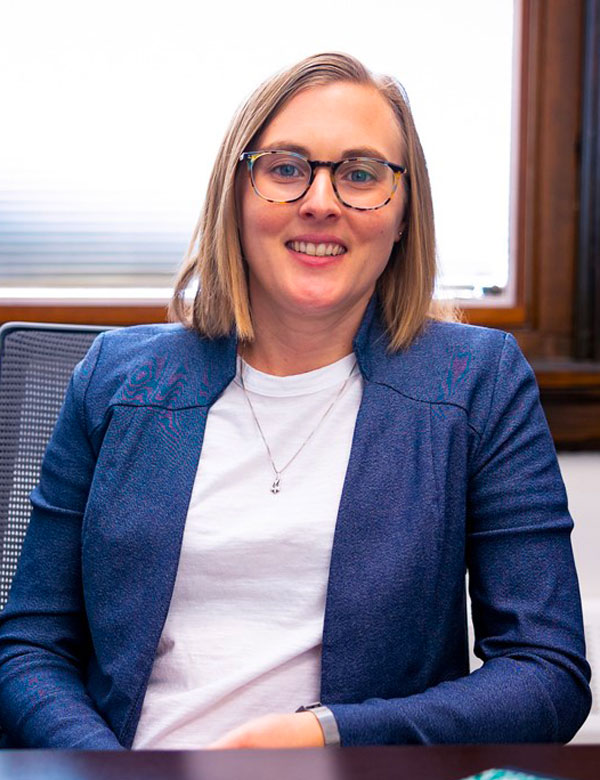 Photograph of Lydia Kisley seated at a desk