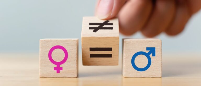 Concepts of gender equality. Hand flip wooden cube with symbol unequal change to equal sign