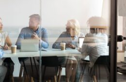 Business people negotiating at boardroom behind closed doors