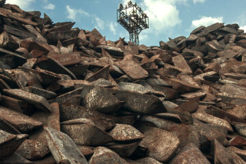 a pile of rust-colored iron ore ingots