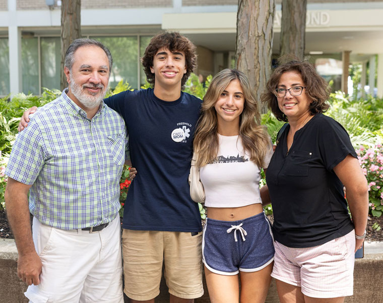 A family poses at Case Western Reserve University move-in