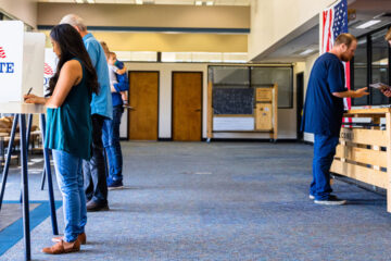 Photo of people in voting booths at a polling location