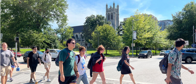 Students crossing the street at the intersection of Adelbert Road and Euclid Avenue on a sunny day