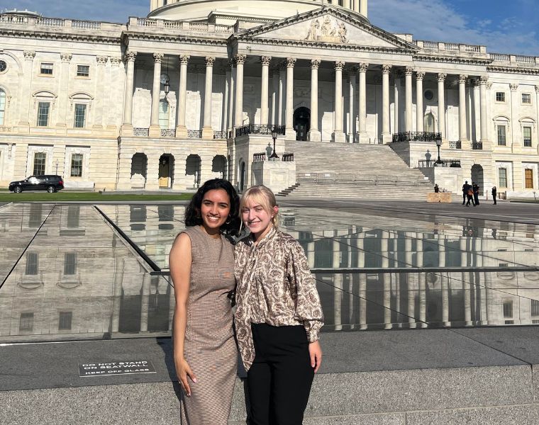Sarah Zigo and Amber Akhter stand in front of Capitol Hill building