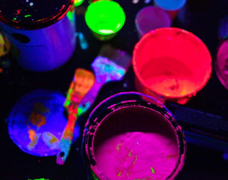 Close up of glow in the dark paint cans and brushes