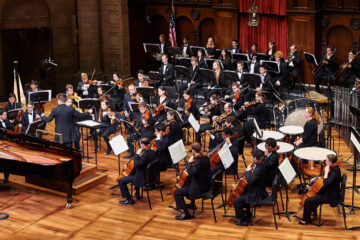 Photo of a CWRU orchestra performing on stage