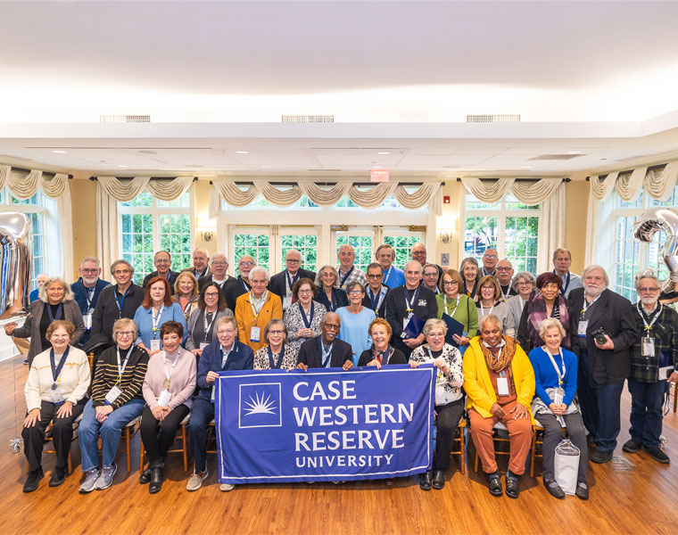 Group photo of the CWRU 1973 alumni posing with a CWRU banner