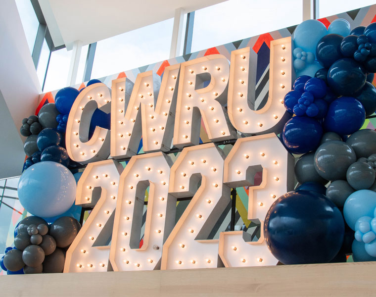 Photo of "CWRU 2023" spelled out in marquee letters and surrounded in balloons on the stairs in Tinkham Veale University Center during homecoming 2023