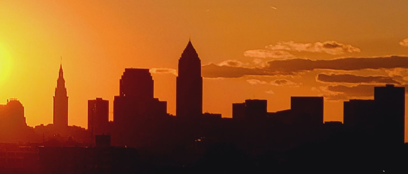 Dramatic orange silhouette of Cleveland Ohio skyline at sunset