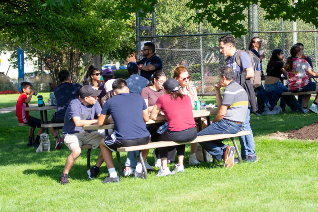 Photo of CWRU students and their families gathered together for a picnic during Envision Weekend
