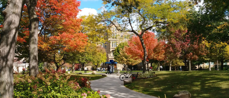 Photo of the CWRU campus during fall with Adelbert Hall framed by vibrant trees