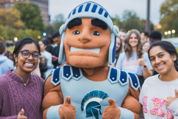 Photo of two CWRU students posing for a photo with Spartie