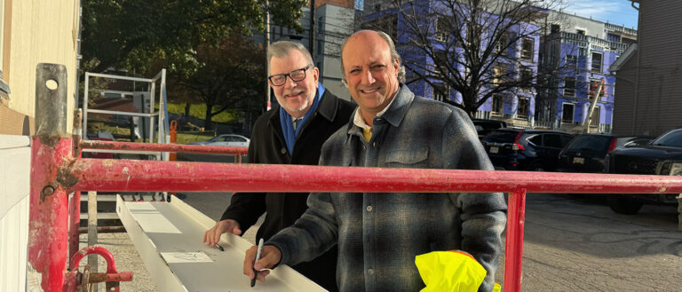 Photo of President Eric Kaler and Board of Trustees Chair Fred DiSanto signing a beam for the south residential village