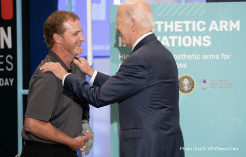 Photo of Brandon Prestwood with President Joe Biden's hands on his shoulders