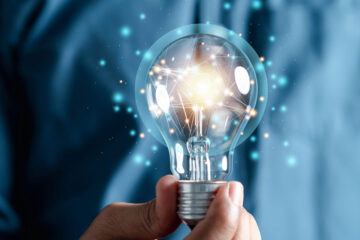 man holding a lightbulb, symbolizing an idea