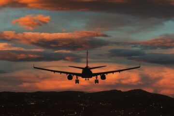 An aircraft prepares to touch down against a backdrop of dramatic sunset skies. Courtesy of Getty Images