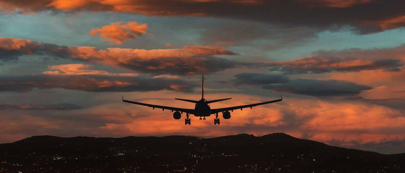 An aircraft prepares to touch down against a backdrop of dramatic sunset skies. Courtesy of Getty Images