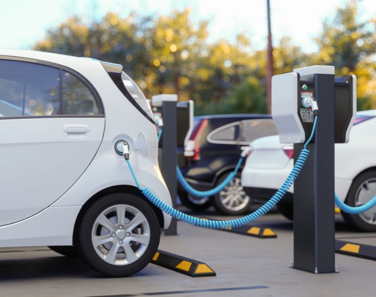 Close-up View Of Charging Electric Car In Parking Lot. Courtesy of Getty Images.