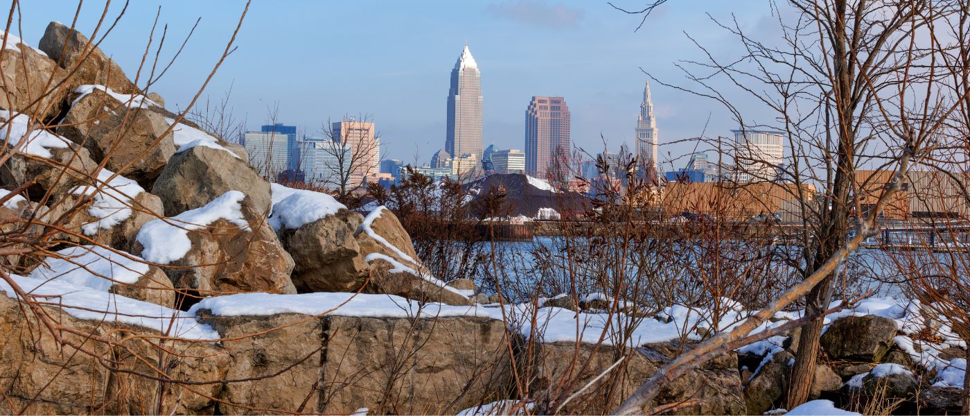 Views of Clevelands skyline beyound boulders and shrubs along the wintery shoreline of Lake Erie at Edgewater Park in Cleveland, Ohio. Courtesy of Getty Images.