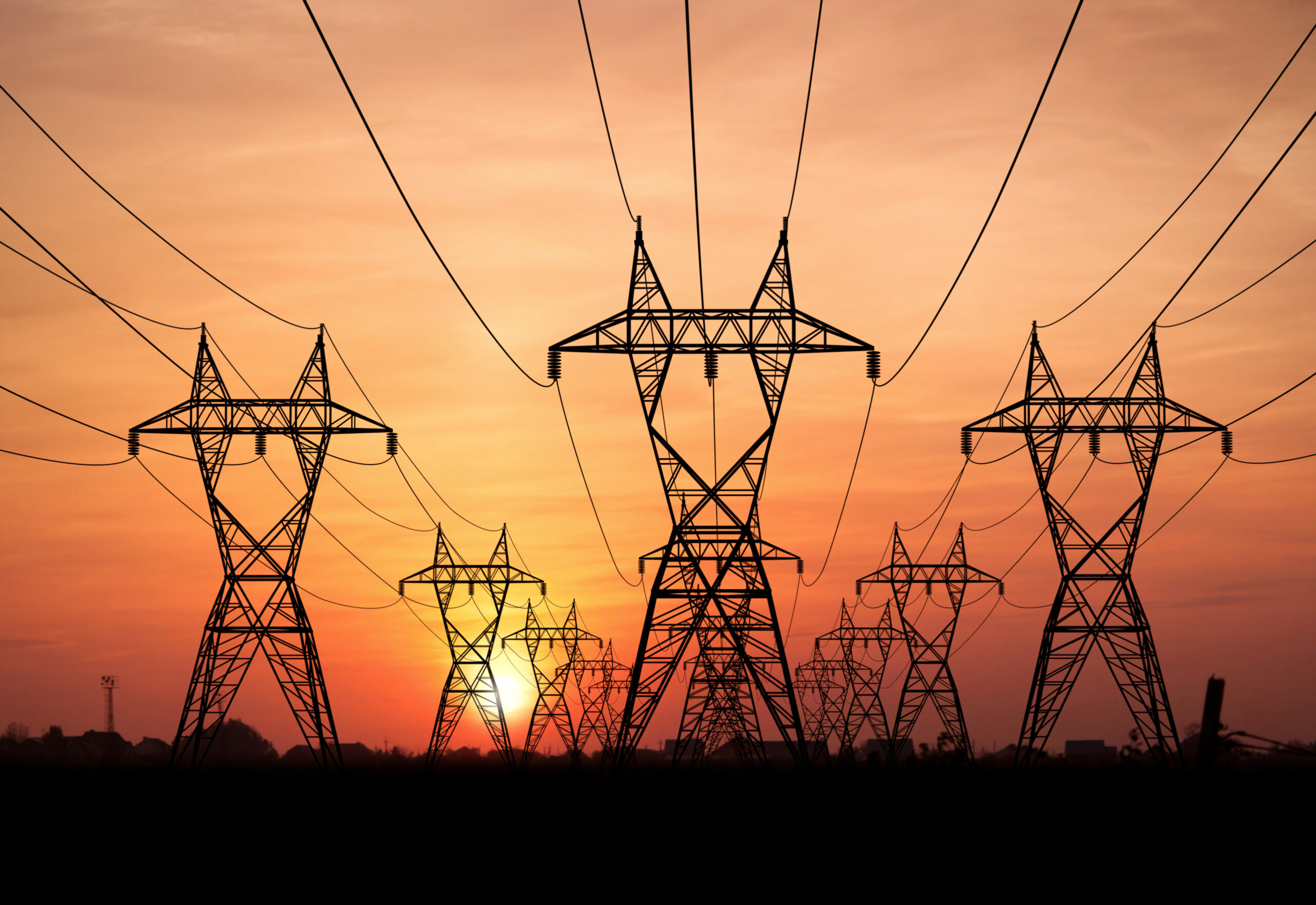 Photo of electric power lines at sunset.