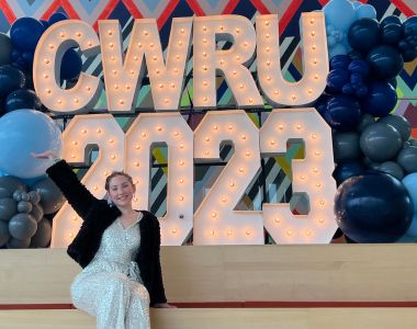 Photo of Milana Sacco poses in front of CWRU 2023 signage.