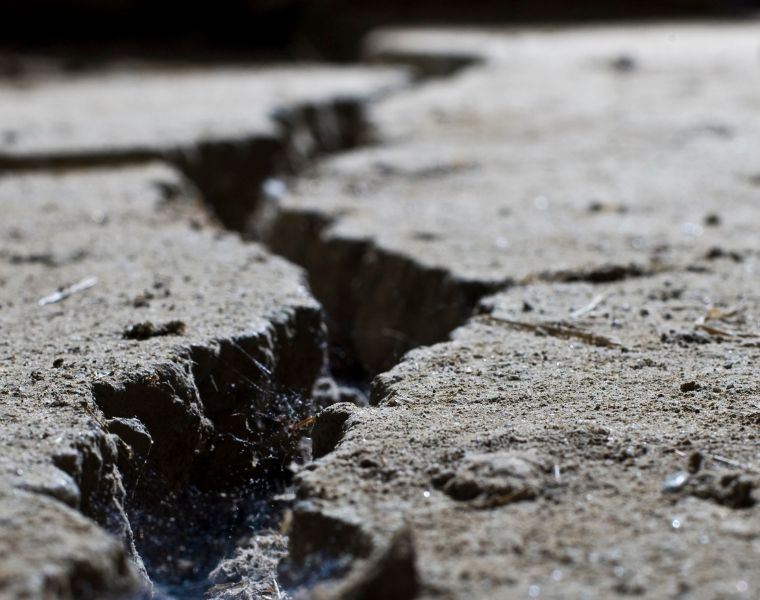 Close up of cracked road concrete. Courtesy of Getty Images.