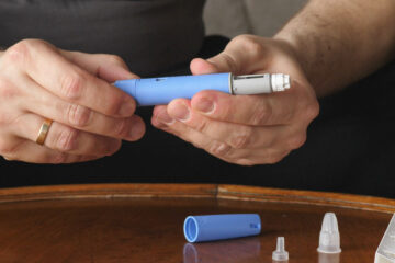 Photo of a person preparing Semaglutide Ozempic injection pen to control blood sugar levels