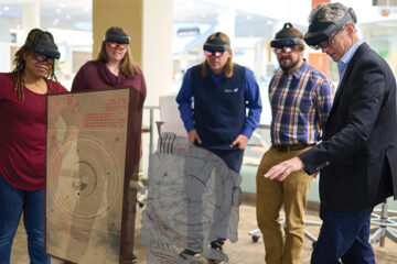 Associate Professor Paul Iversen showing HoloLens images of the Antikythera mechanism to staff members of the Cleveland Museum of Natural History. |