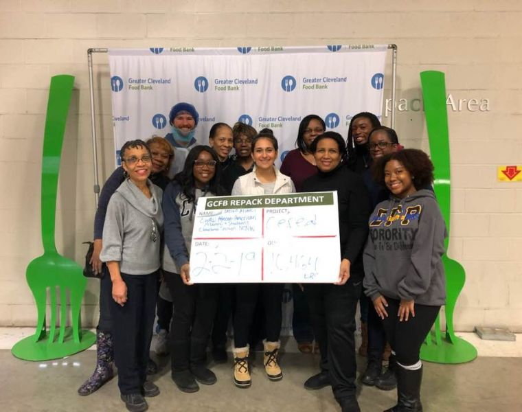 Photo of African American Alumni Association members posing during a volunteer project at the Greater Cleveland Food Bank