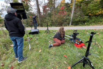 Patricia Carrig works as a production assistant operating a dolly on a film set.
