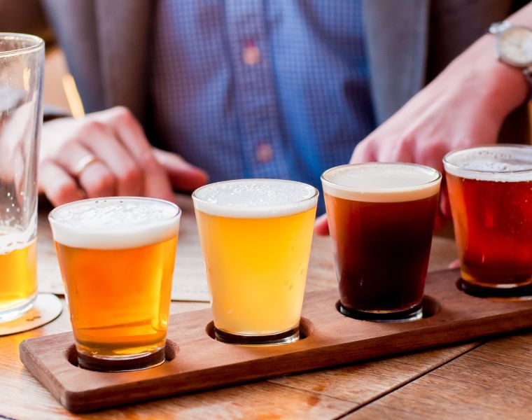 Selection of craft beers in a flight ready for tasting. Courtesy of Getty Images.