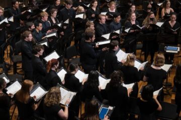 Side view of CWRU choir singing during homecoming in 2022.