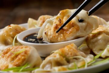 Pan Fried Asian Pork Dumplings with Soy Sauce and Green Onions. Courtesy of Getty Images.