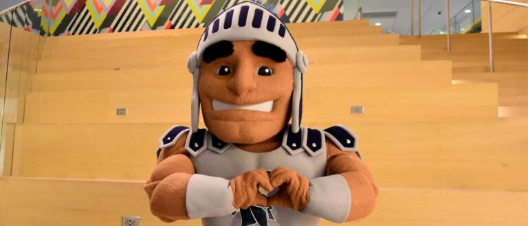 Photo of Spartie mascot holding hands in the shape of a heart.