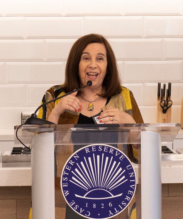 Photo of Hope Barkoukis speaking at a podium in the CWRU Nutrition Kitchen