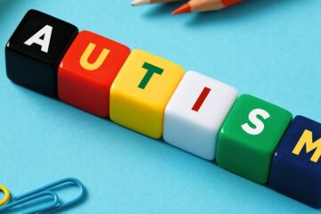 Close up of multicolor blocks that spell "AUTISM"