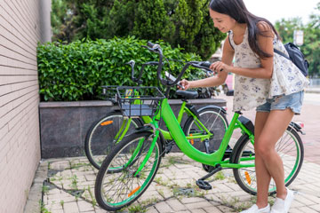 Photo of a person accessing a bike from a bike share location